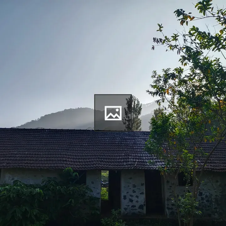 Broken building with mountain backdrop