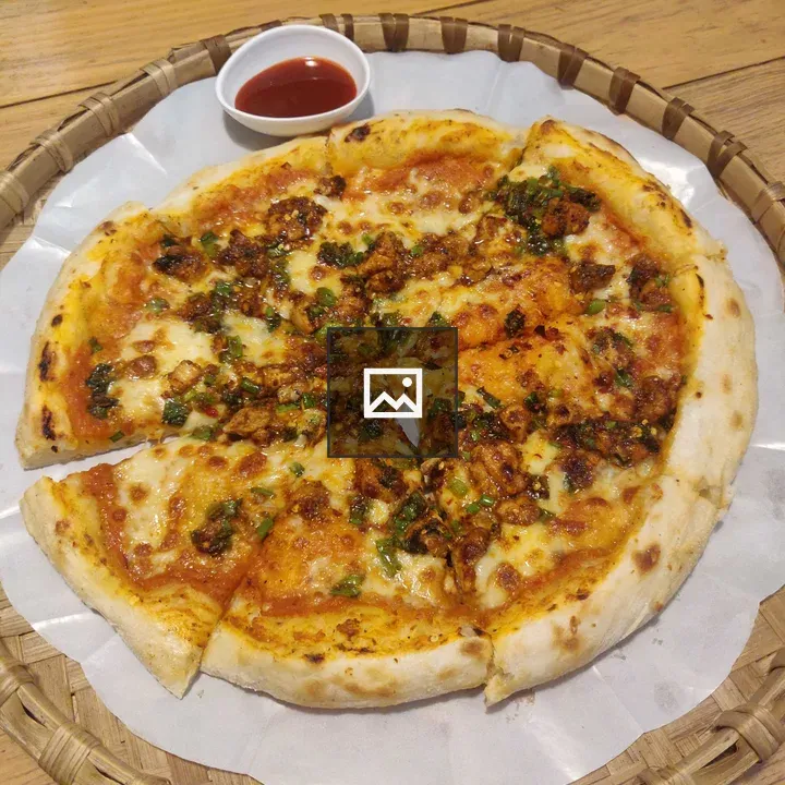 Pizza on table with sauce