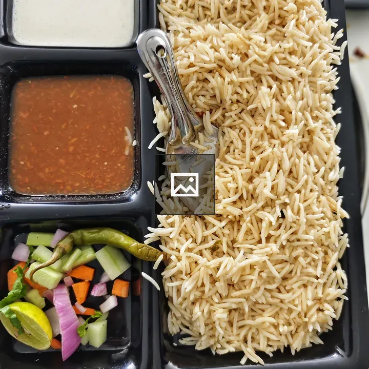 A divided food tray with rice
