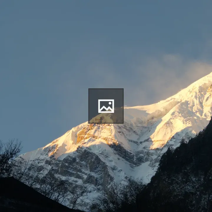 Snow-covered mountain peak at sunrise
