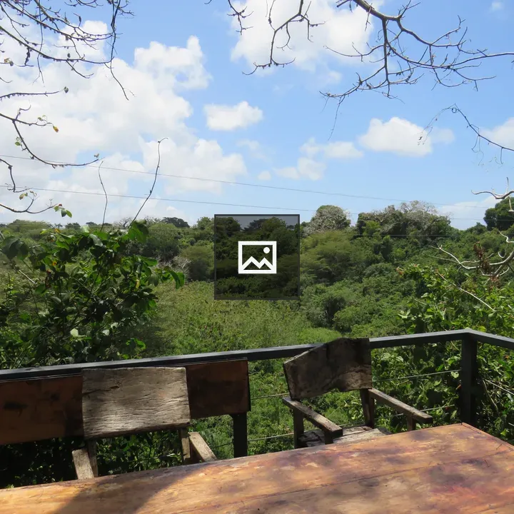 Rustic table and chairs on deck overlooking valley