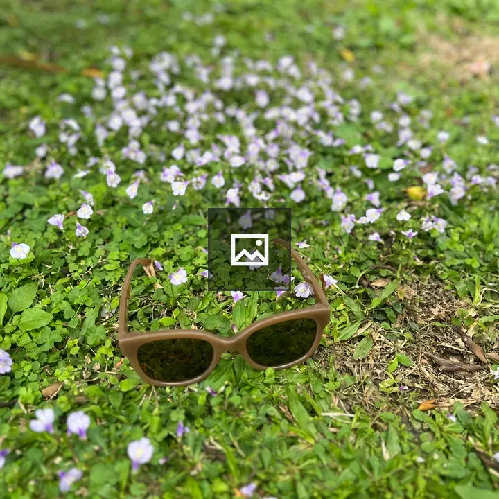 Sunglasses on Grass with Flowers