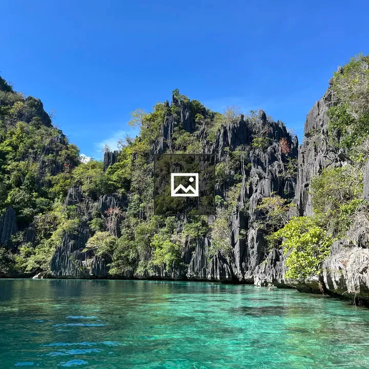 Clear water before cliffs