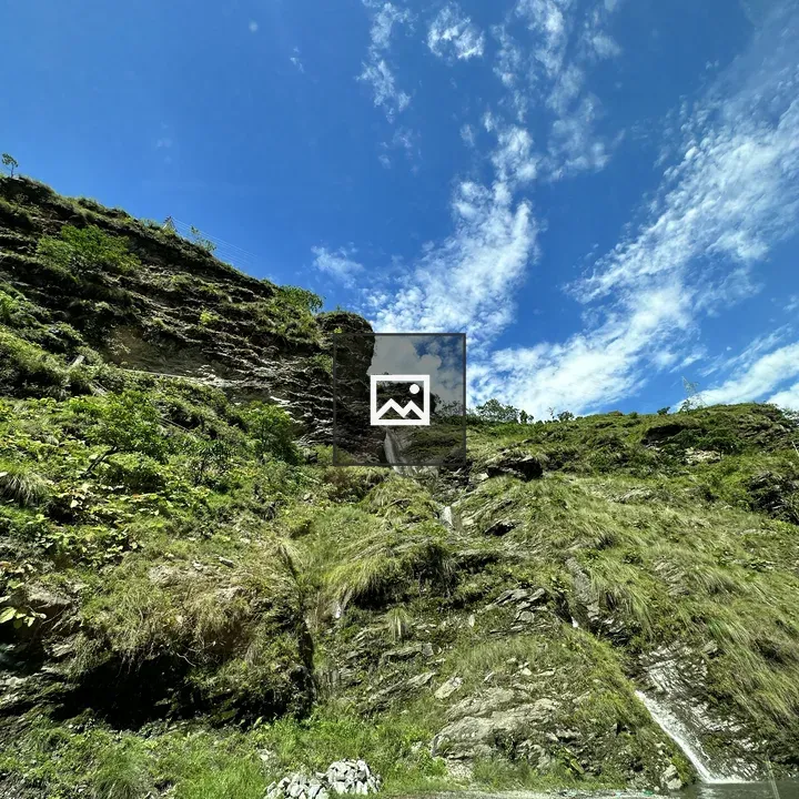 Waterfall on grassy hill