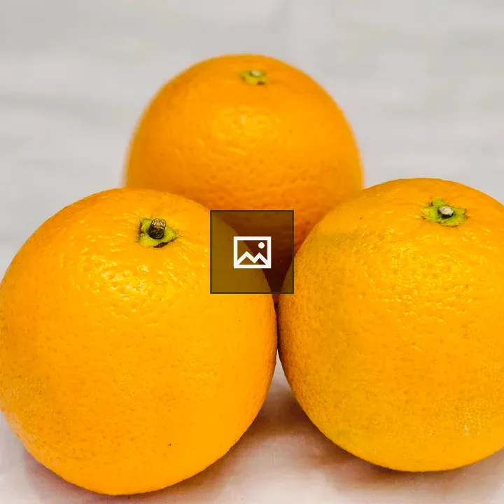 Three Oranges on Light Surface