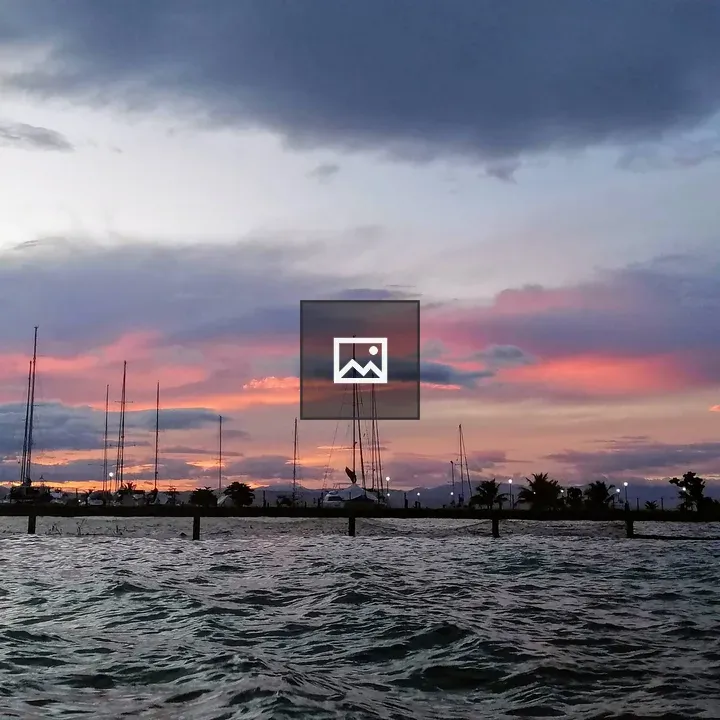 Beach at dusk with sailboats