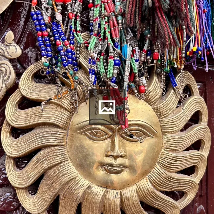 Decorative sun face with jewelry wall