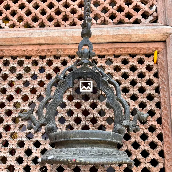 Antique metal bell and lattice window