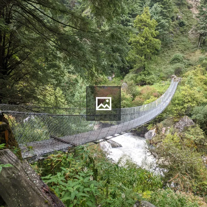 Suspension bridge over rocky river