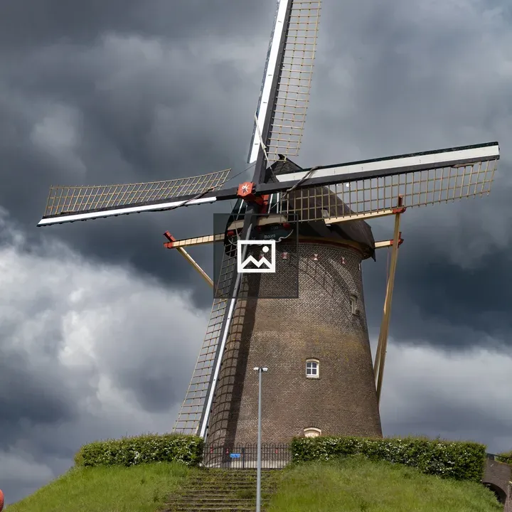 Windmill on grassy hill in Wijchen