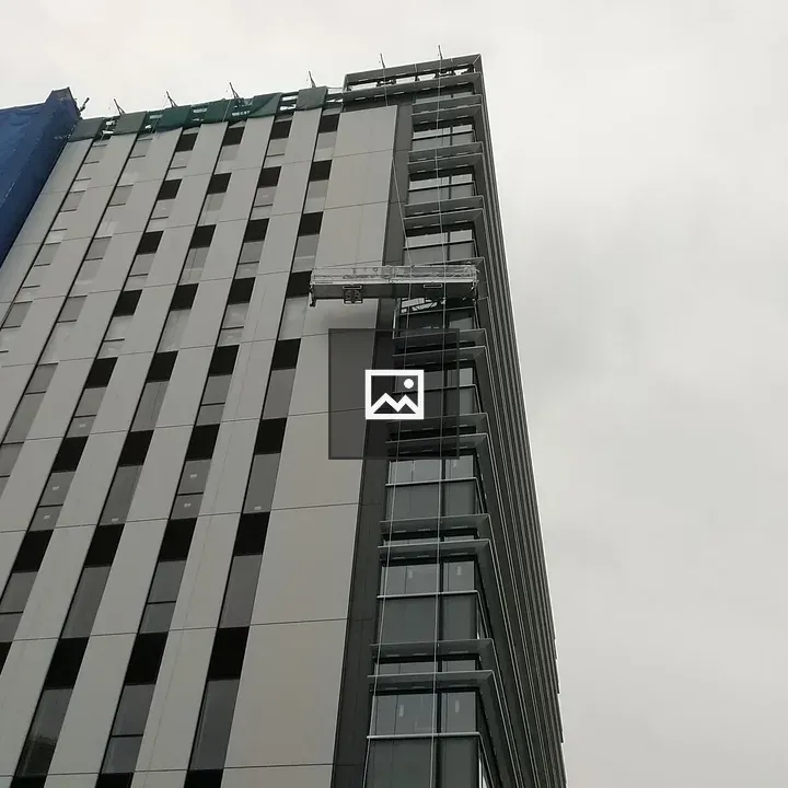 Tall building with workers in gondola