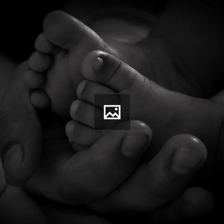Tiny baby feet in hands
