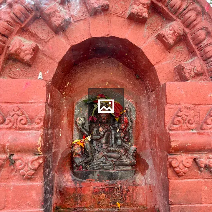 Red brick shrine with deity statue