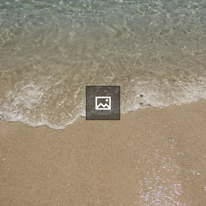 Beach shoreline with white foam