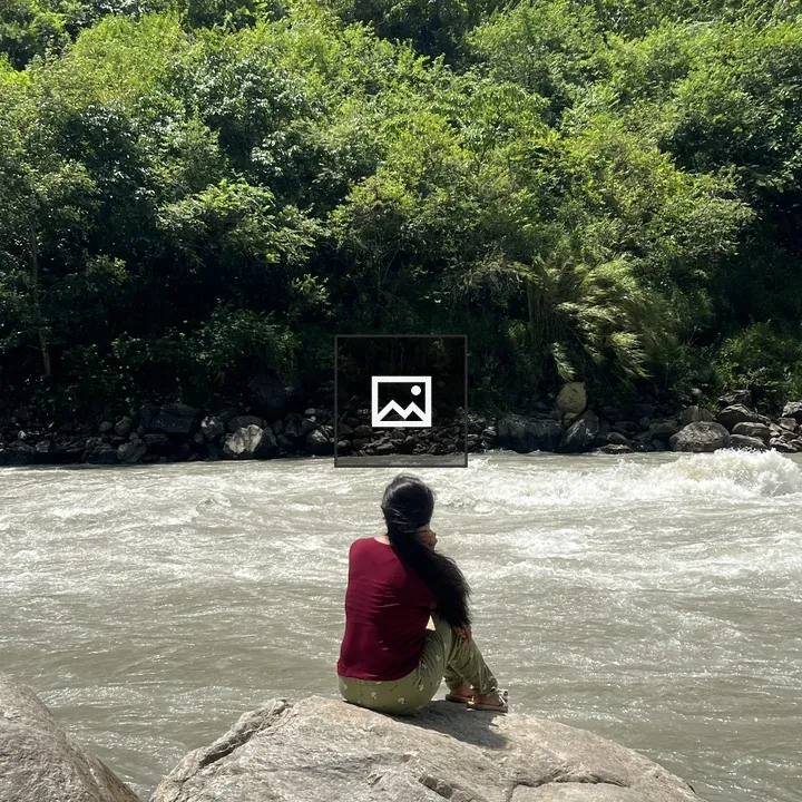 Person on Rock by River