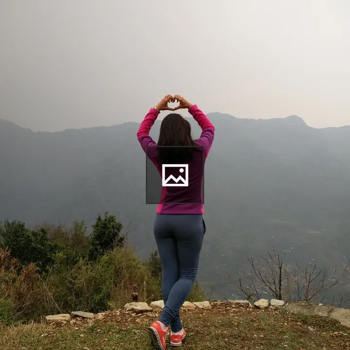 Woman with Heart Hands on Grassland Overlook