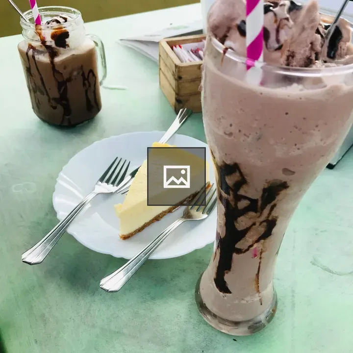 Cheese pastry on plate with chocolate drinks
