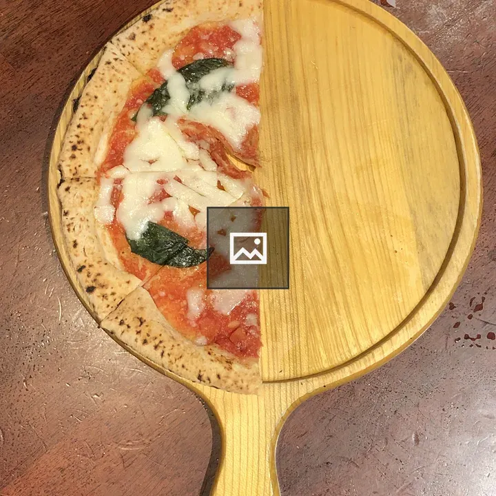 Half-eaten pizza on peel