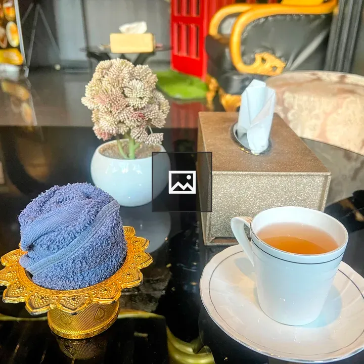 Tea, towel, tissue, and plant on table