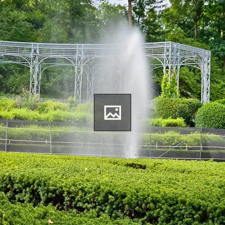 Water fountain in garden trellis scene