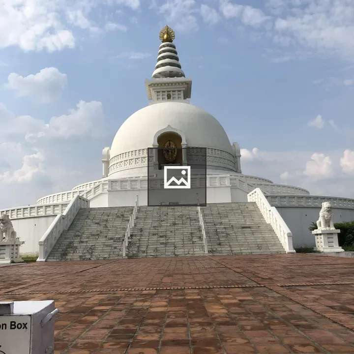 Stupa with Buddha statue on steps
