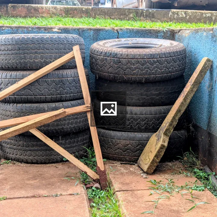 Stacked tires by blue wall