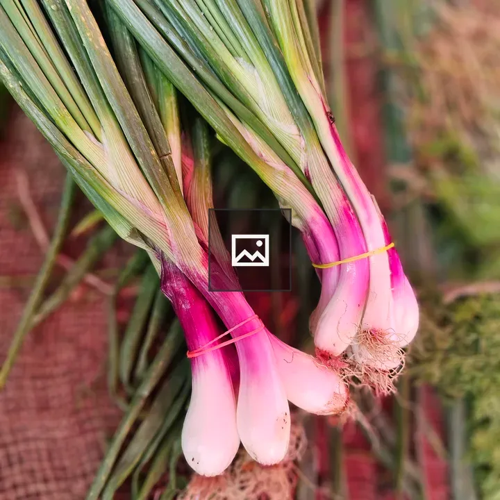 Fresh spring onions at stall