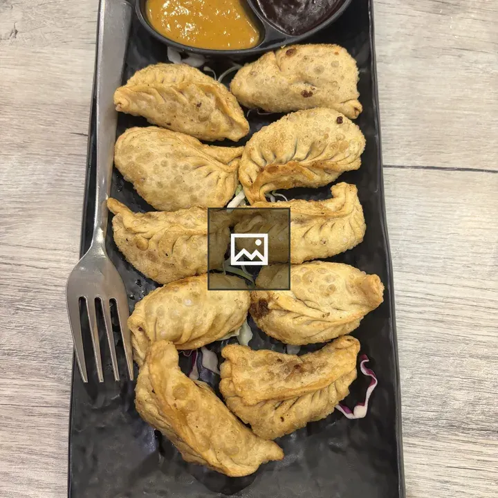Fried dumplings on black plate