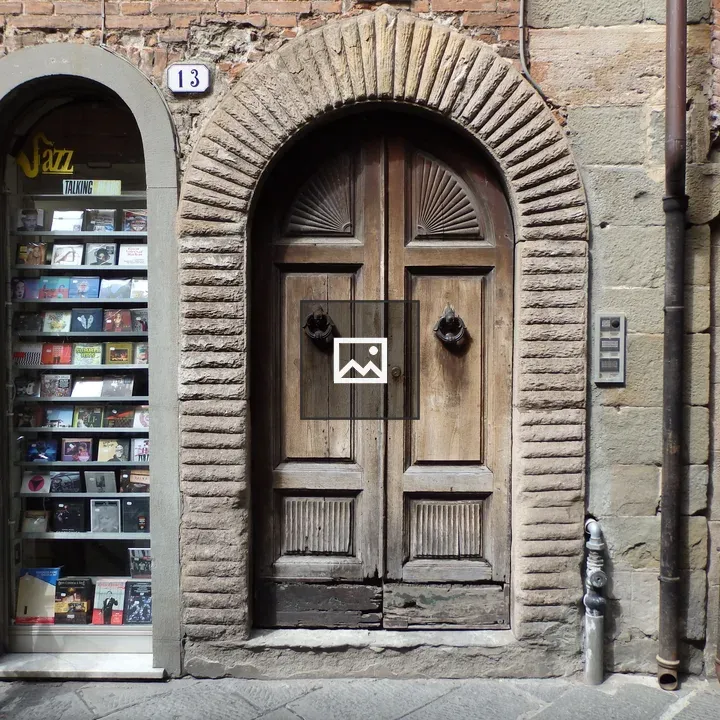 Wooden arched door by music shop window