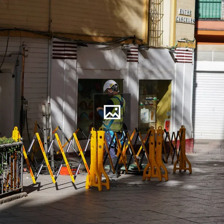 Construction worker in alley with barriers
