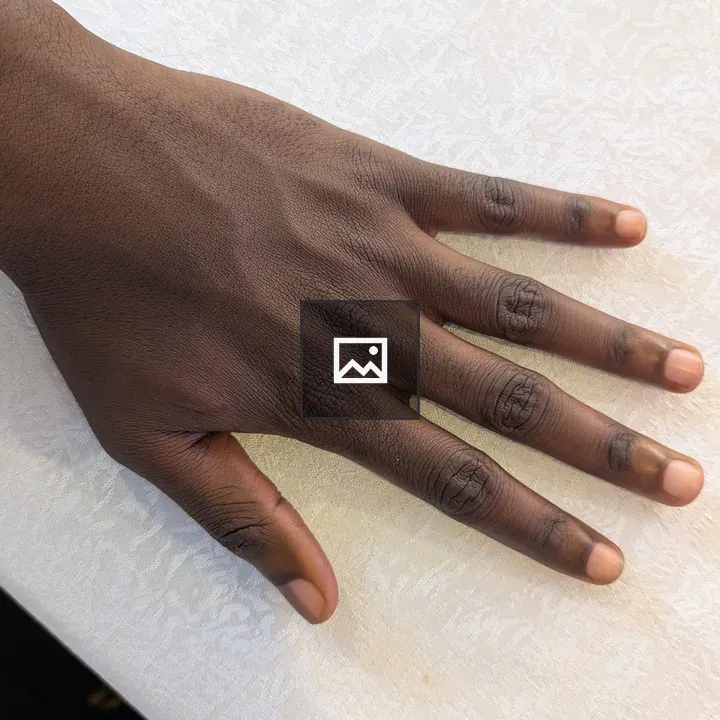Close-up of a Relaxed Hand on Tablecloth