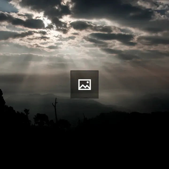 Sunlit Clouds Over Dark Mountains