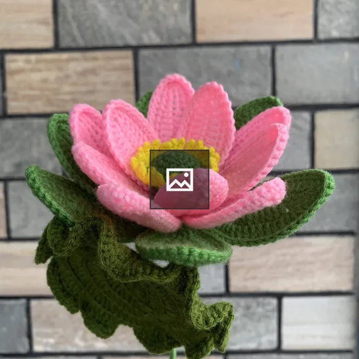 Crochet Flower Against Stone Wall