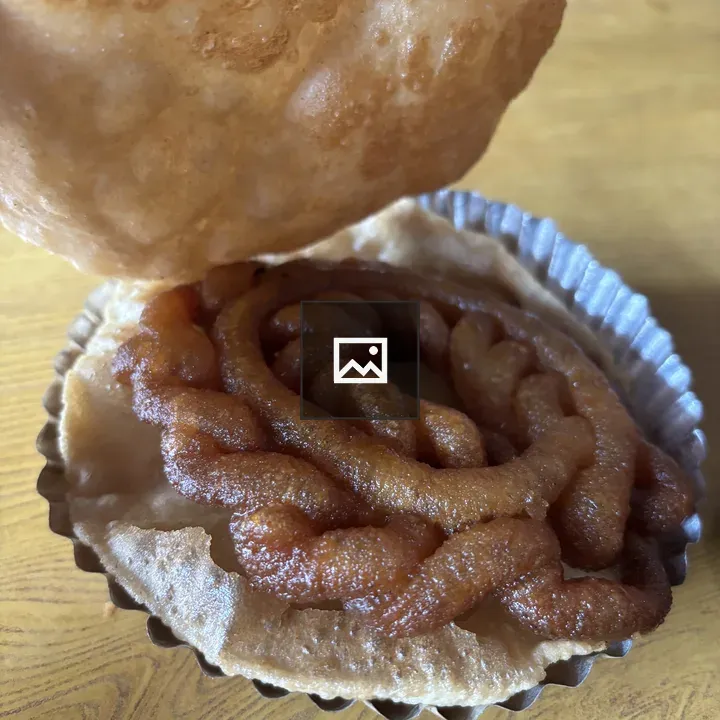 Golden-brown puri with syrupy semolina dessert
