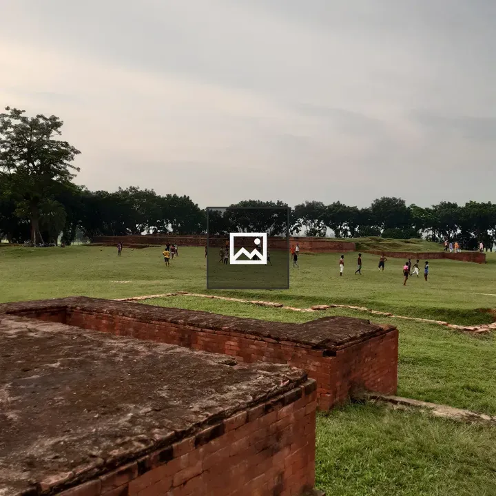 Soccer on grassy field near ruins