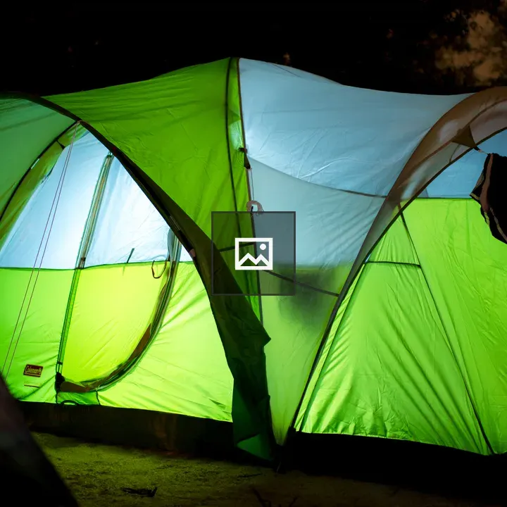 Camping tent illuminated at night