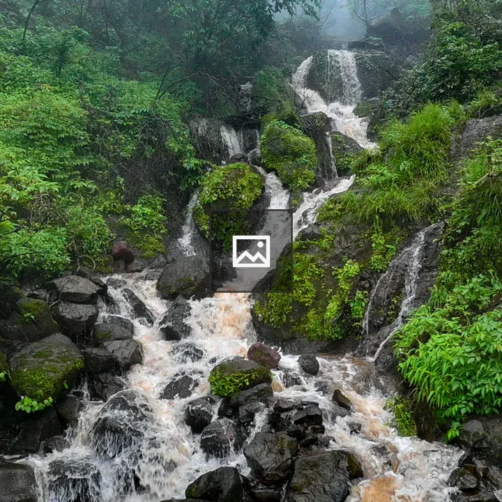 Waterfall over dark rocks