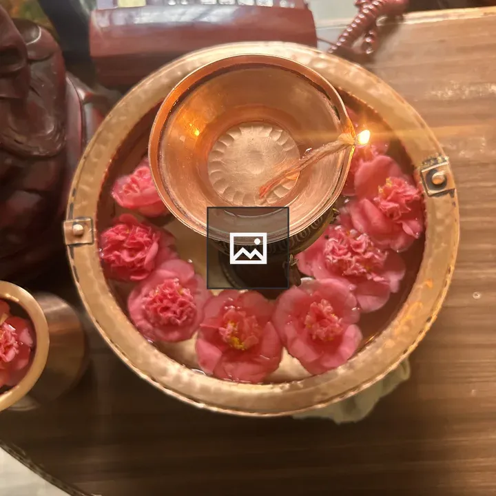 Copper bowl with flowers and lamp