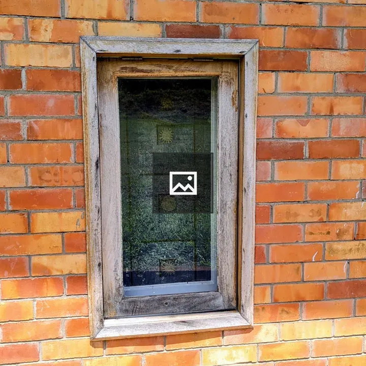 Rustic window with brick wall