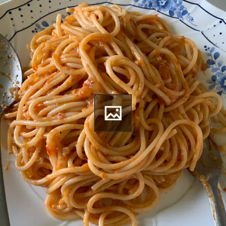 Plate of spaghetti with reddish sauce