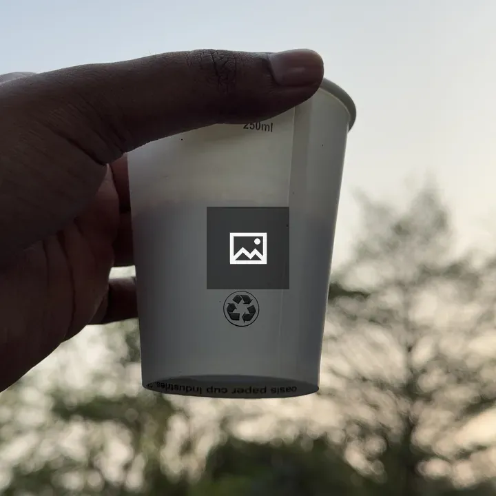 Hand holding white tea cup