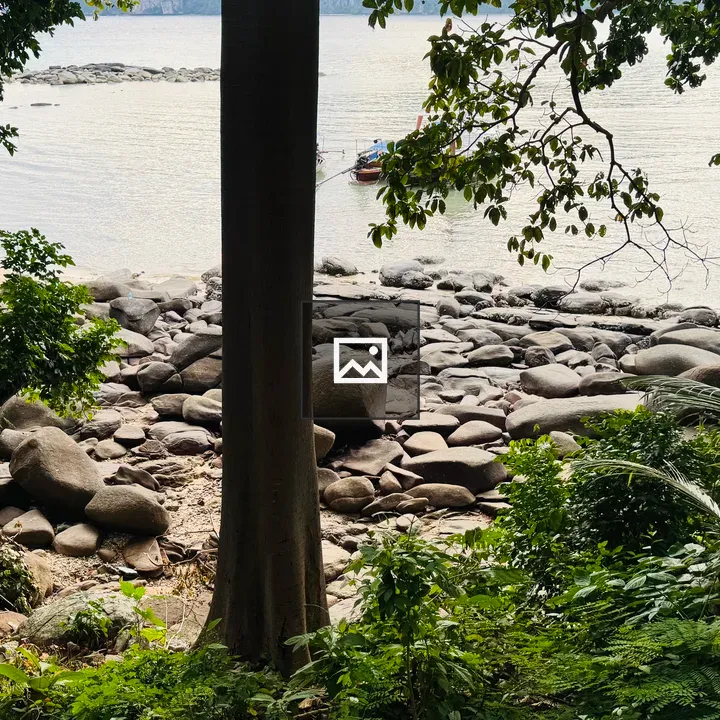 Rocky shoreline with boats view