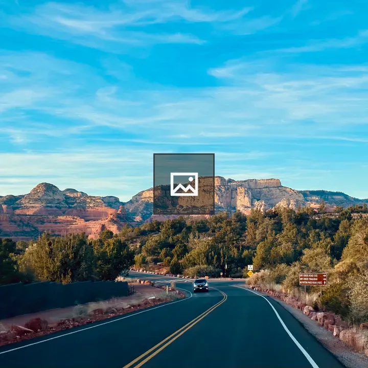 Winding road toward red rock mountains