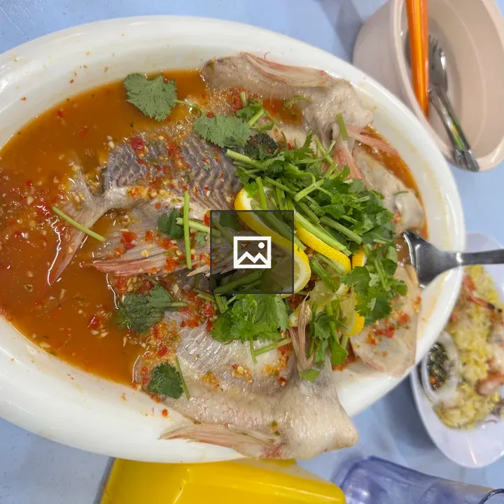 Steamed fish with herbs on plate