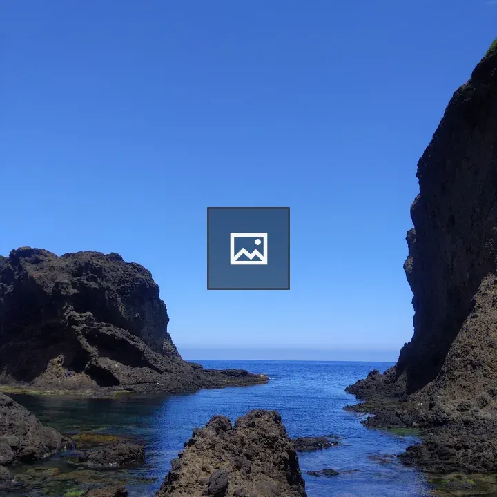 A Cove with Dark Rock Formations