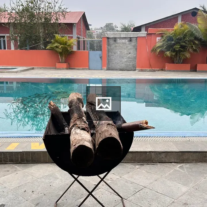 Black fire pit with logs and pool