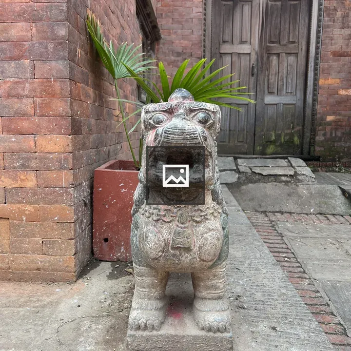 Stone lion statue guarding building