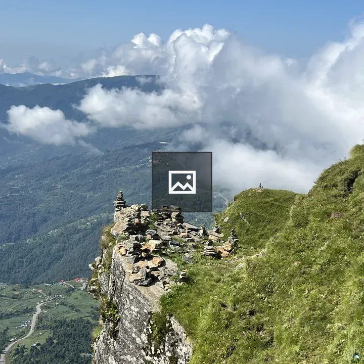 Cliff with stone cairns over valley