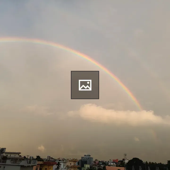 Rainbow over cloudy sky