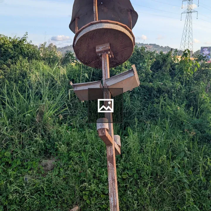 Rusty street light in grass